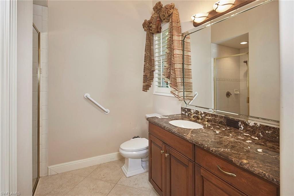 5669 Sago Court Naples, FL 34119 - Photo 22 of 41 Full bathroom with vanity, a stall shower, and light tile floors