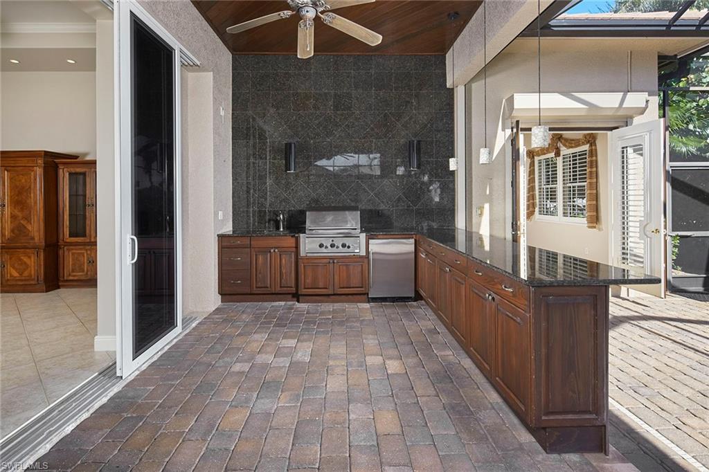 5669 Sago Court Naples, FL 34119 - Photo 24 of 41 Huge lanai with outdoor kitchen and ceiling fan