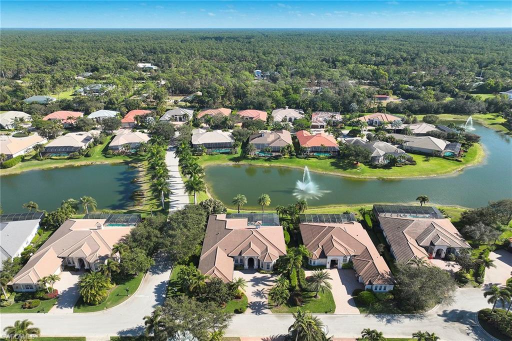 5669 Sago Court Naples, FL 34119 - Photo 31 of 41 Aerial view of property and surrounding area featuring a large body of water and nearby suburban area