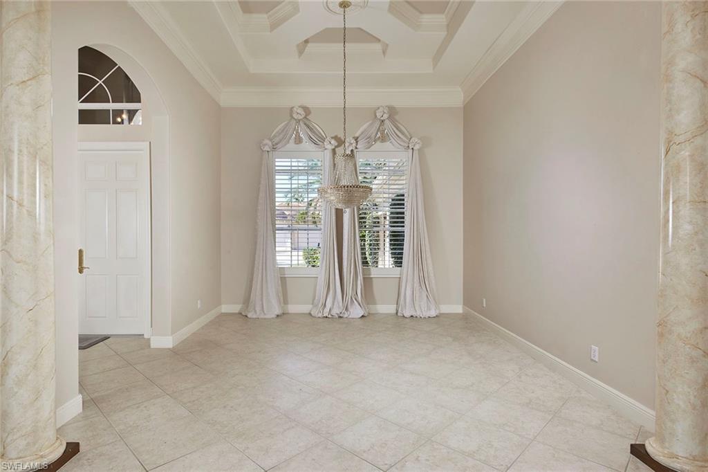 5669 Sago Court Naples, FL 34119 - Photo 6 of 41 Dining room featuring a chandelier, arched walkways, and crown molding