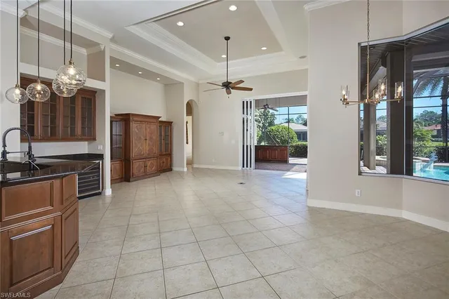 a view of a kitchen with a sink and a refrigerator