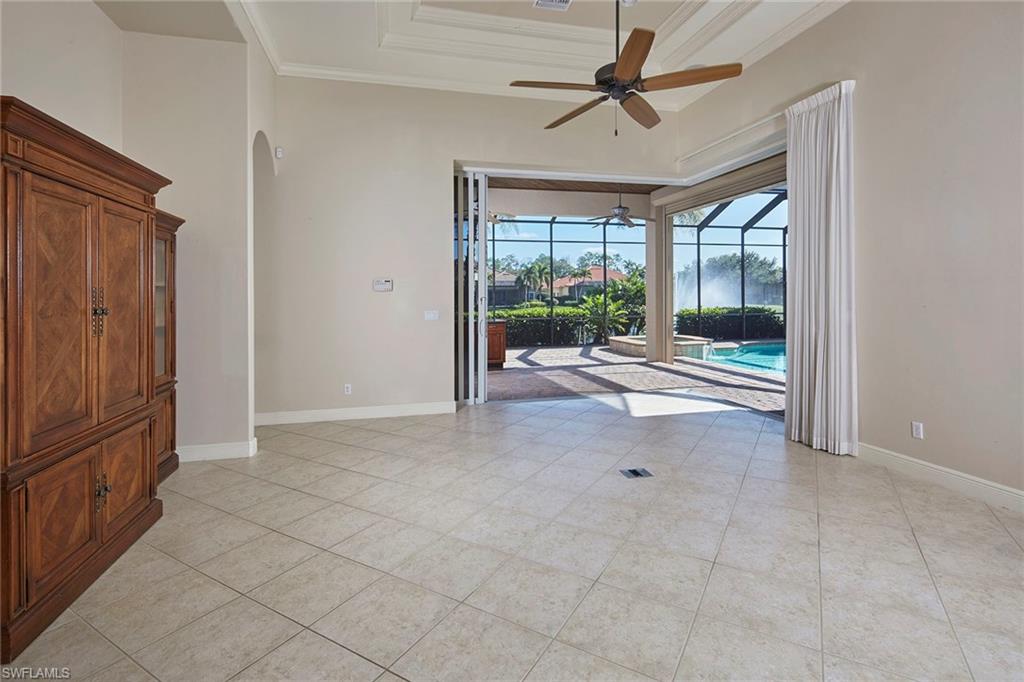 5669 Sago Court Naples, FL 34119 - Photo 8 of 41 Family room with ornamental molding, ceiling fan, a tray ceiling, and light tile flooring