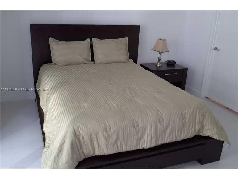 Brickell Miami, FL 33131 - Photo 4 of 14 a bedroom with a bed and a night stand