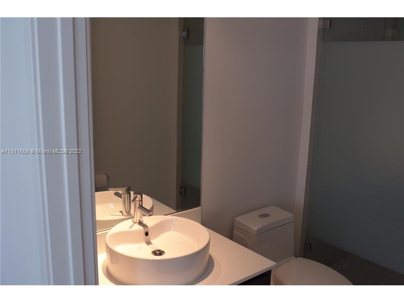 Brickell Miami, FL 33131 - Photo 5 of 14 a bathroom with a sink and a mirror