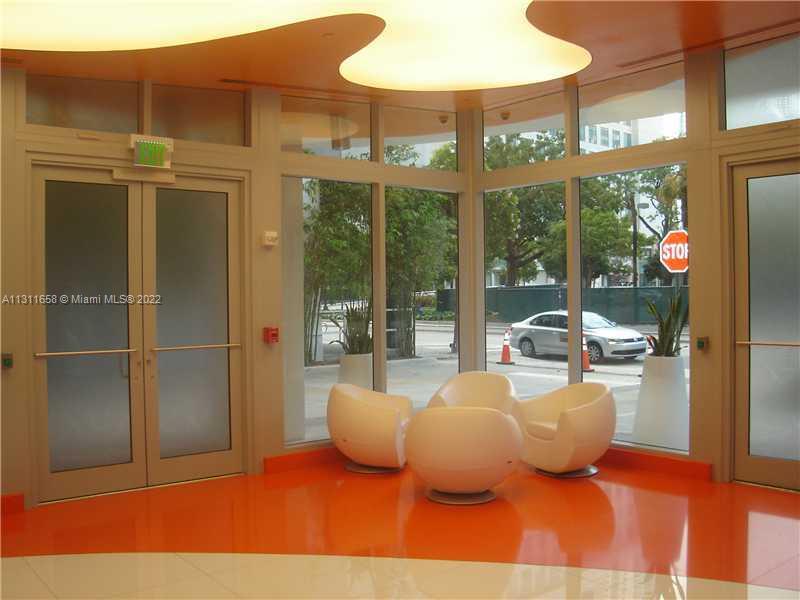 Brickell Miami, FL 33131 - Photo 7 of 14 a room with furniture and a large window