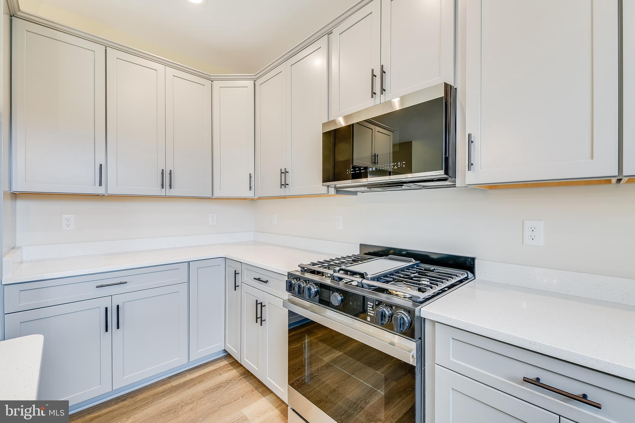 503 South Farm Crossing Road Severn, MD 21144 - Photo 14 of 46 a kitchen with white cabinets and appliances
