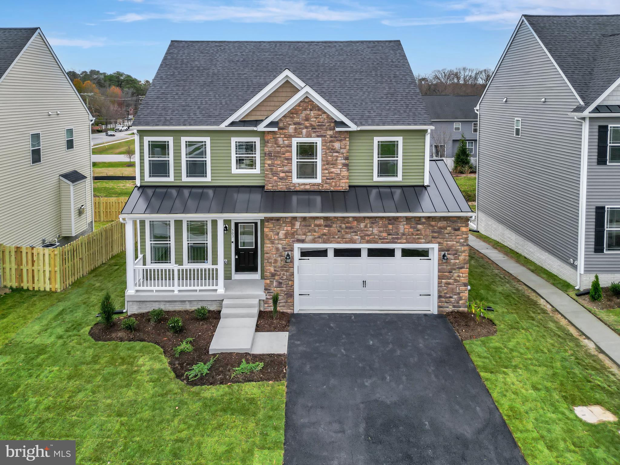503 South Farm Crossing Road Severn, MD 21144 - Photo 2 of 46 a front view of a house with a yard and porch