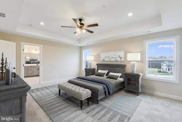 a view of an empty room with wooden floor and a kitchen