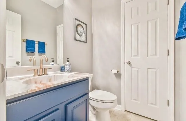 a bathroom with a sink a toilet and a mirror