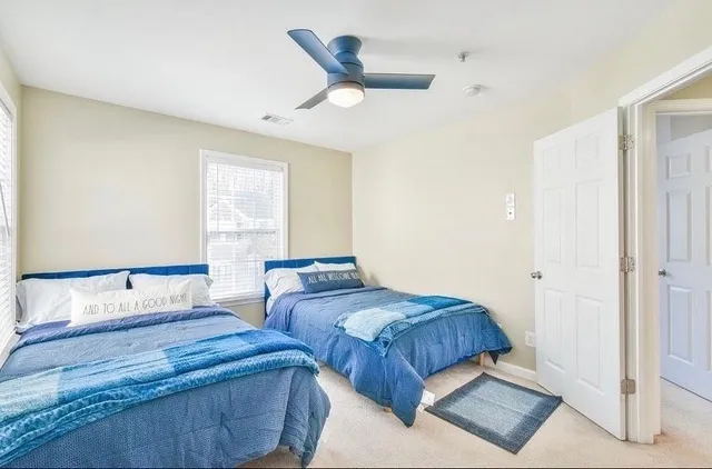 a bedroom with two beds and painted walls