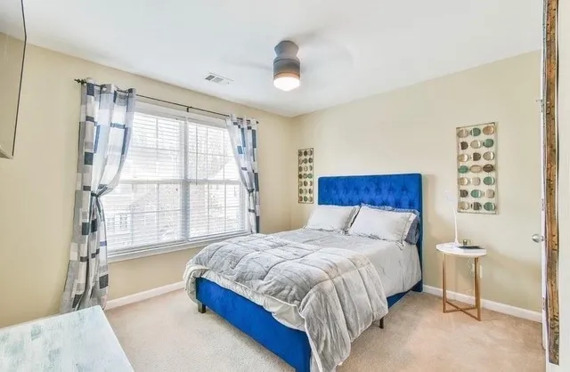 a bedroom with a large bed and a large window