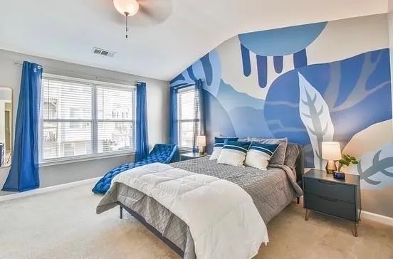 a spacious bedroom with a bed and a chandelier