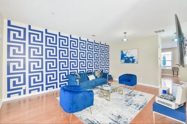 a living room with furniture and wooden floor
