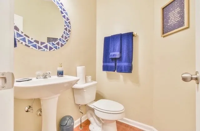 a bathroom with a sink mirror vanity and toilet