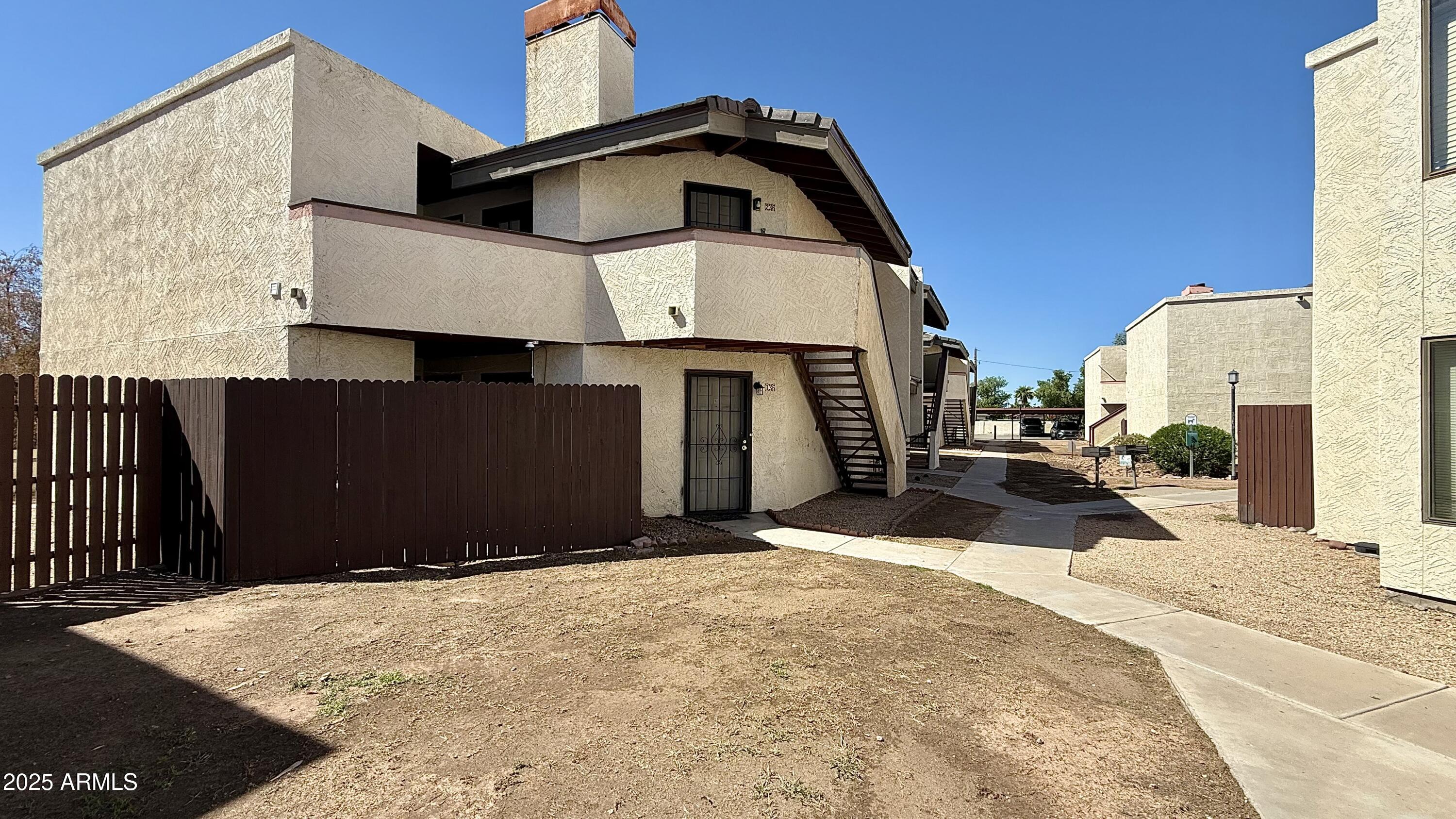 a view of a house with wooden fence