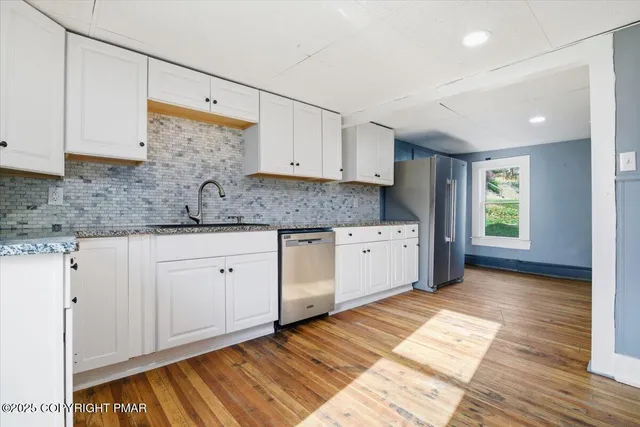 a view of staircase with wooden floor and a window