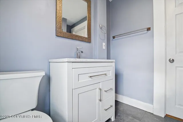 a bathroom with a toilet and a shower curtain