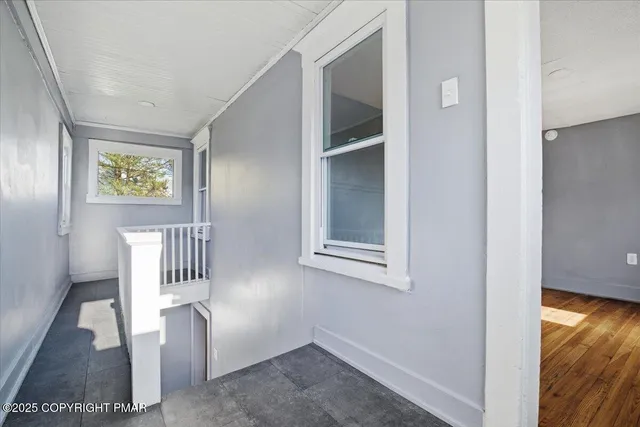 an empty room with wooden floor and closet