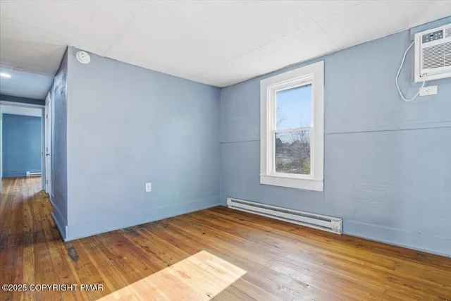 a view of a room with wooden floor