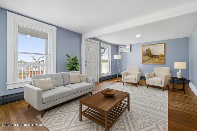a view of an empty room with wooden floor