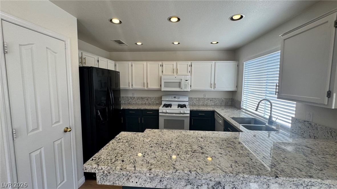 9716 Ridge Creek Place Las Vegas, NV 89134 - Photo 8 of 28 This modern kitchen features spacious granite countertops, perfect for culinary endeavors and entertaining.
