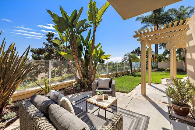 a view of a backyard with plants and a patio