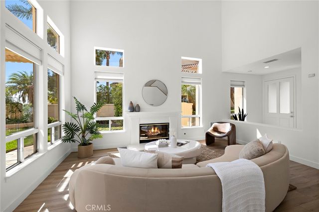 a living room with furniture fireplace and a large window