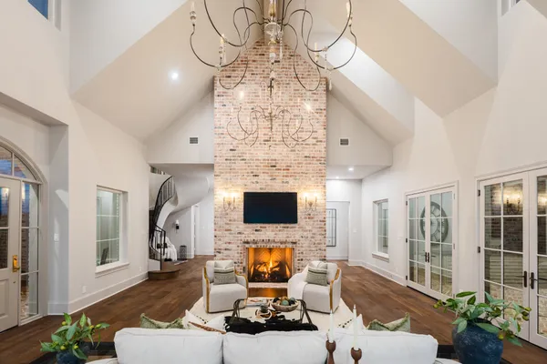 a living room with furniture large window and a fireplace