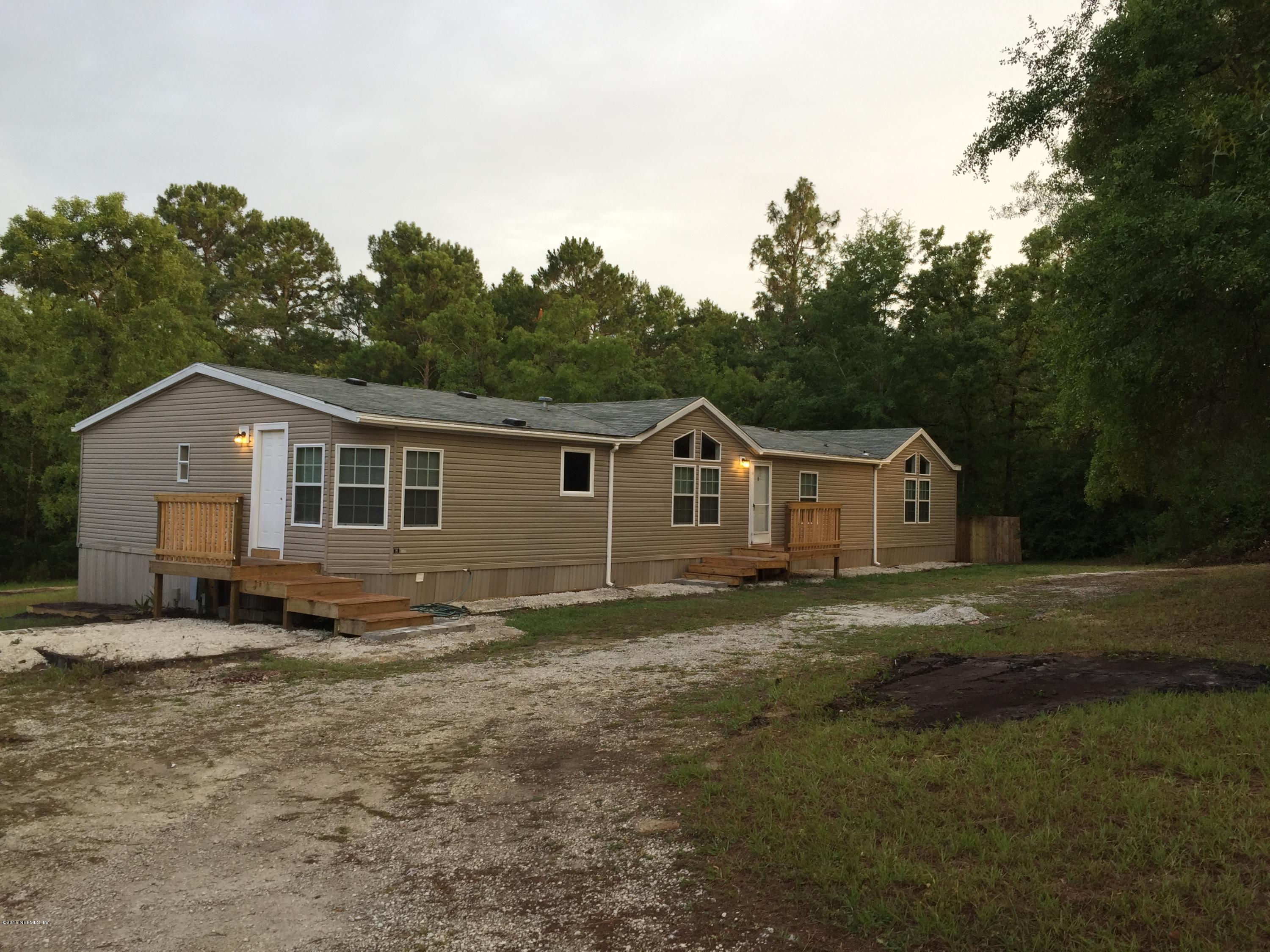 4653 Calendula Avenue Middleburg, FL 32068 - Photo 1 of 50 a front view of a house with a yard