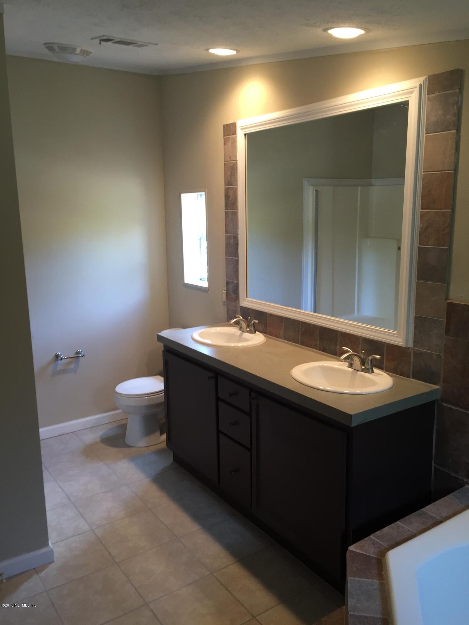 4653 Calendula Avenue Middleburg, FL 32068 - Photo 13 of 50 a bathroom with a sink and a mirror