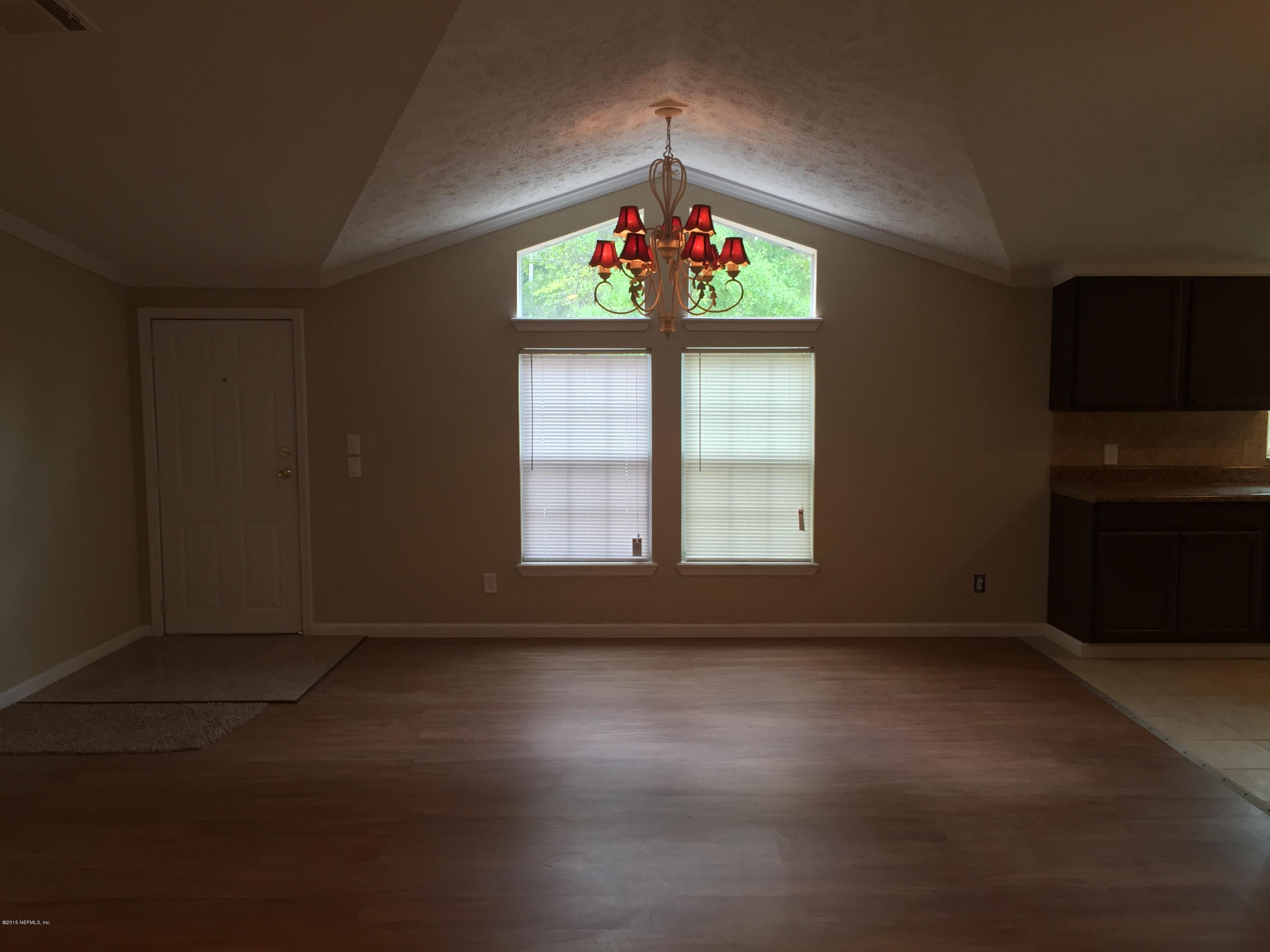 4653 Calendula Avenue Middleburg, FL 32068 - Photo 19 of 50 an empty room with windows and fireplace