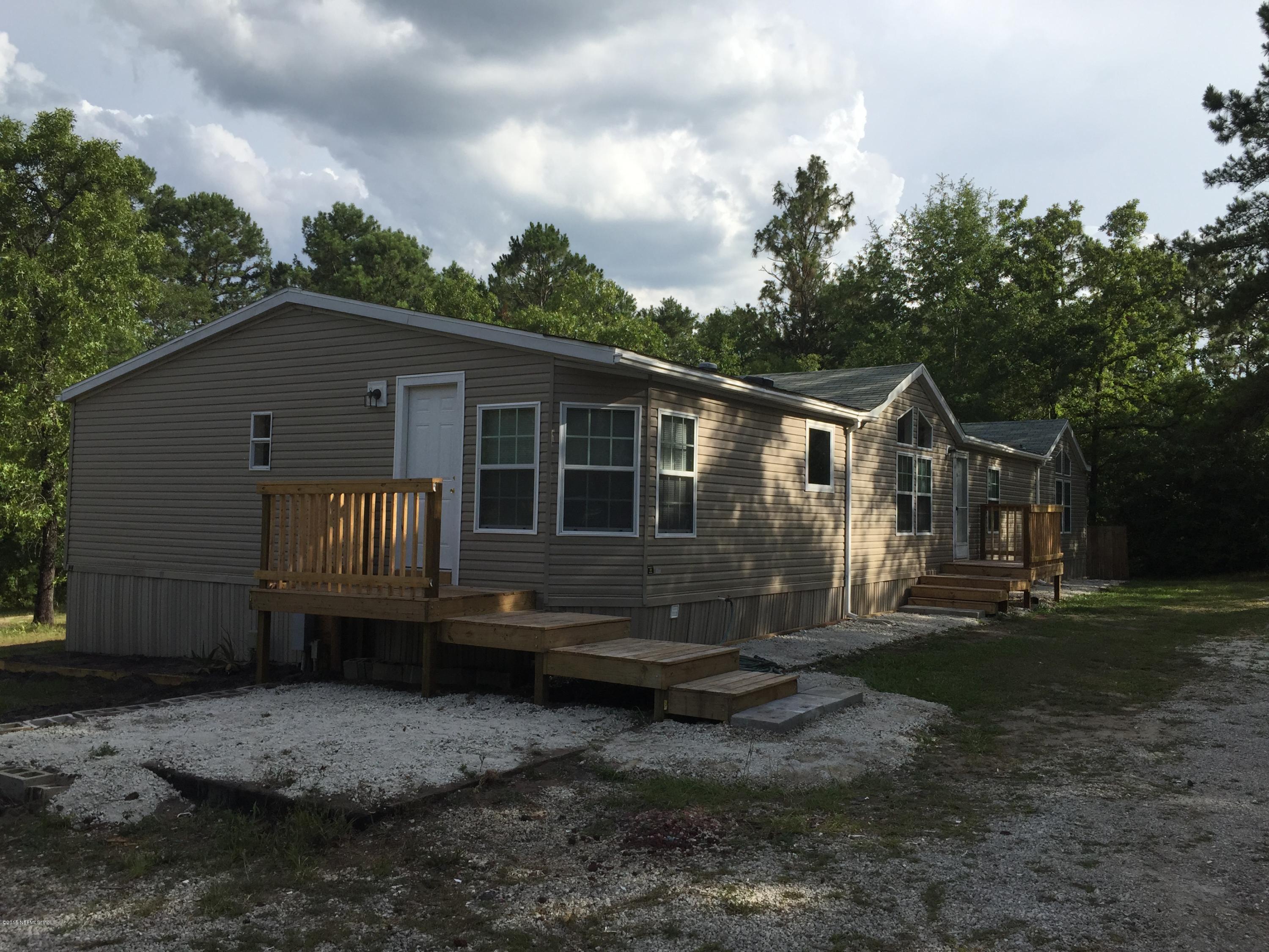 4653 Calendula Avenue Middleburg, FL 32068 - Photo 2 of 50 a view of a house with backyard and trees
