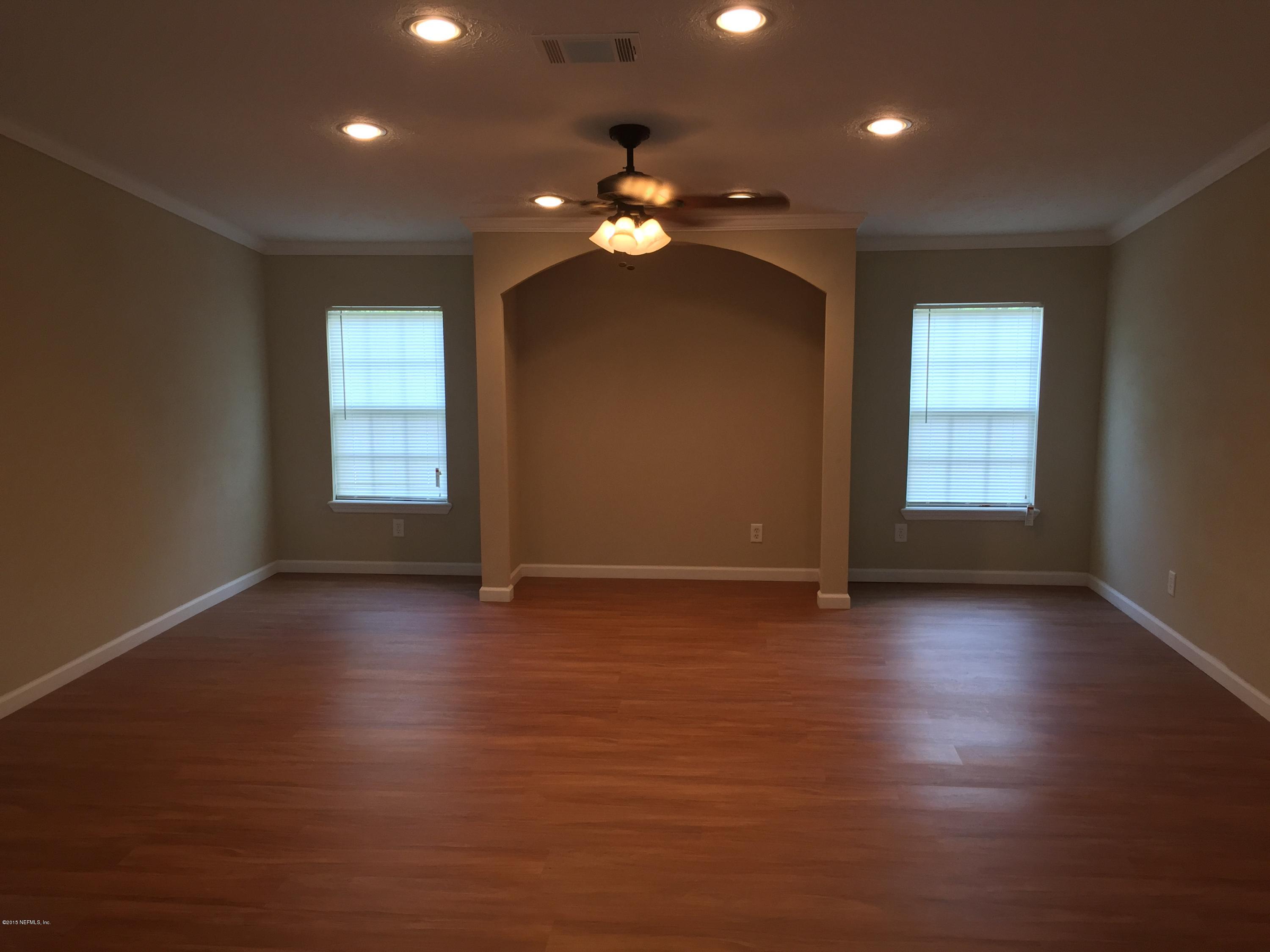 4653 Calendula Avenue Middleburg, FL 32068 - Photo 22 of 50 wooden floor in an empty room with a window