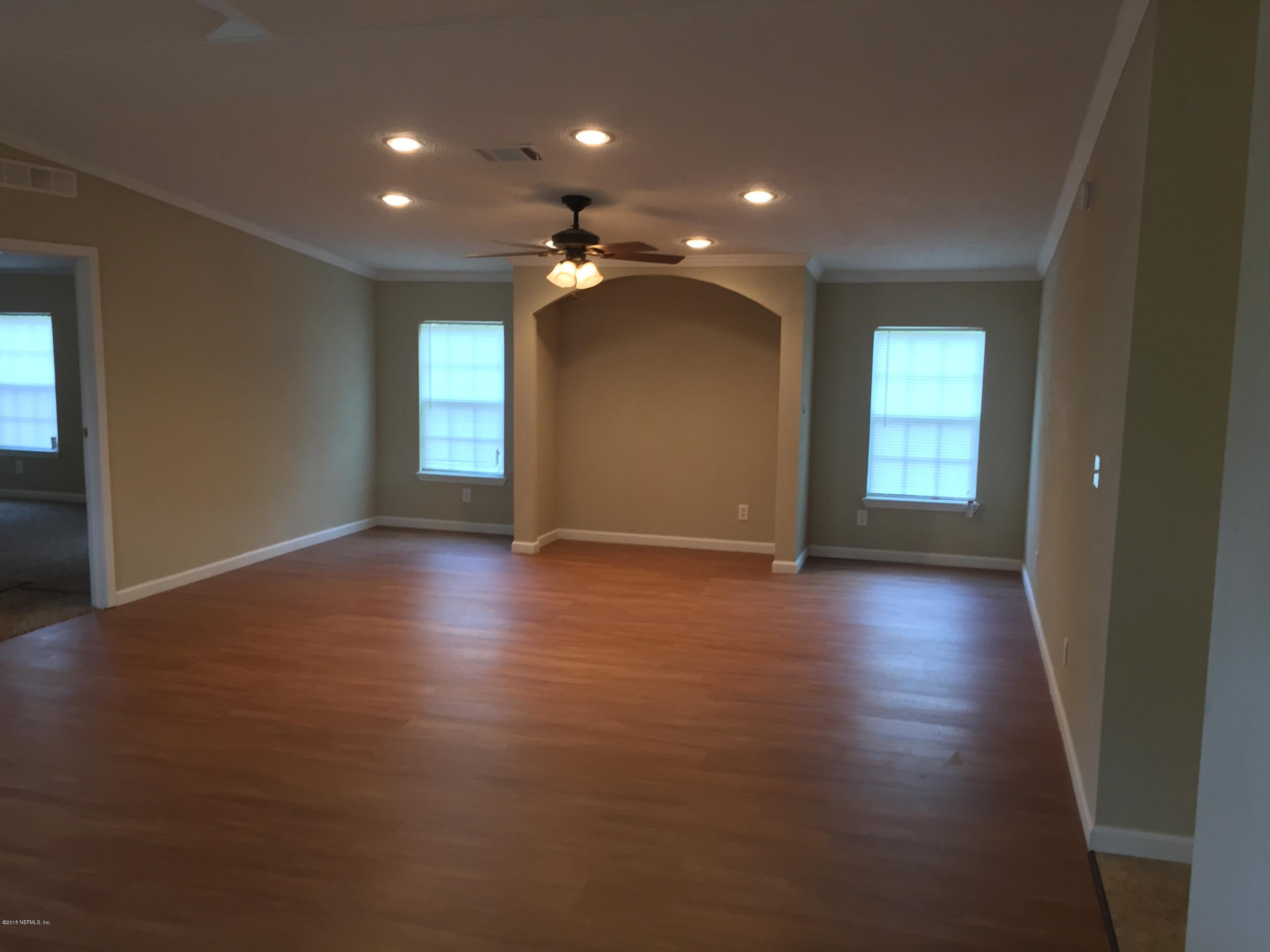 4653 Calendula Avenue Middleburg, FL 32068 - Photo 26 of 50 an empty room with wooden floor and windows