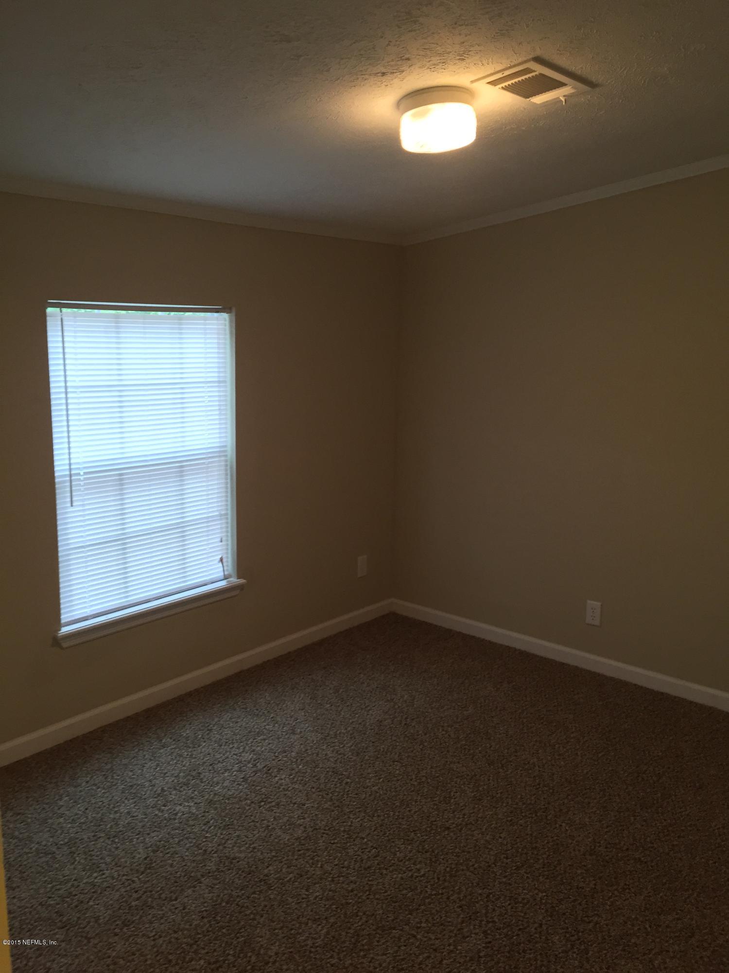 4653 Calendula Avenue Middleburg, FL 32068 - Photo 31 of 50 an empty room with a empty space and windows