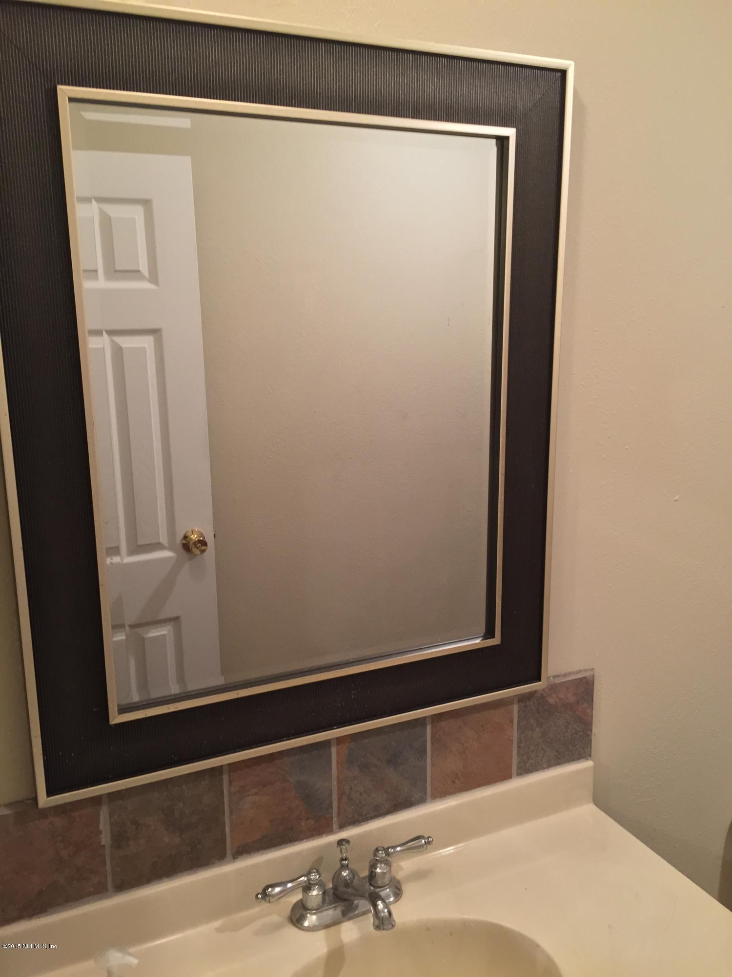 4653 Calendula Avenue Middleburg, FL 32068 - Photo 40 of 50 a bathroom with a sink and a mirror
