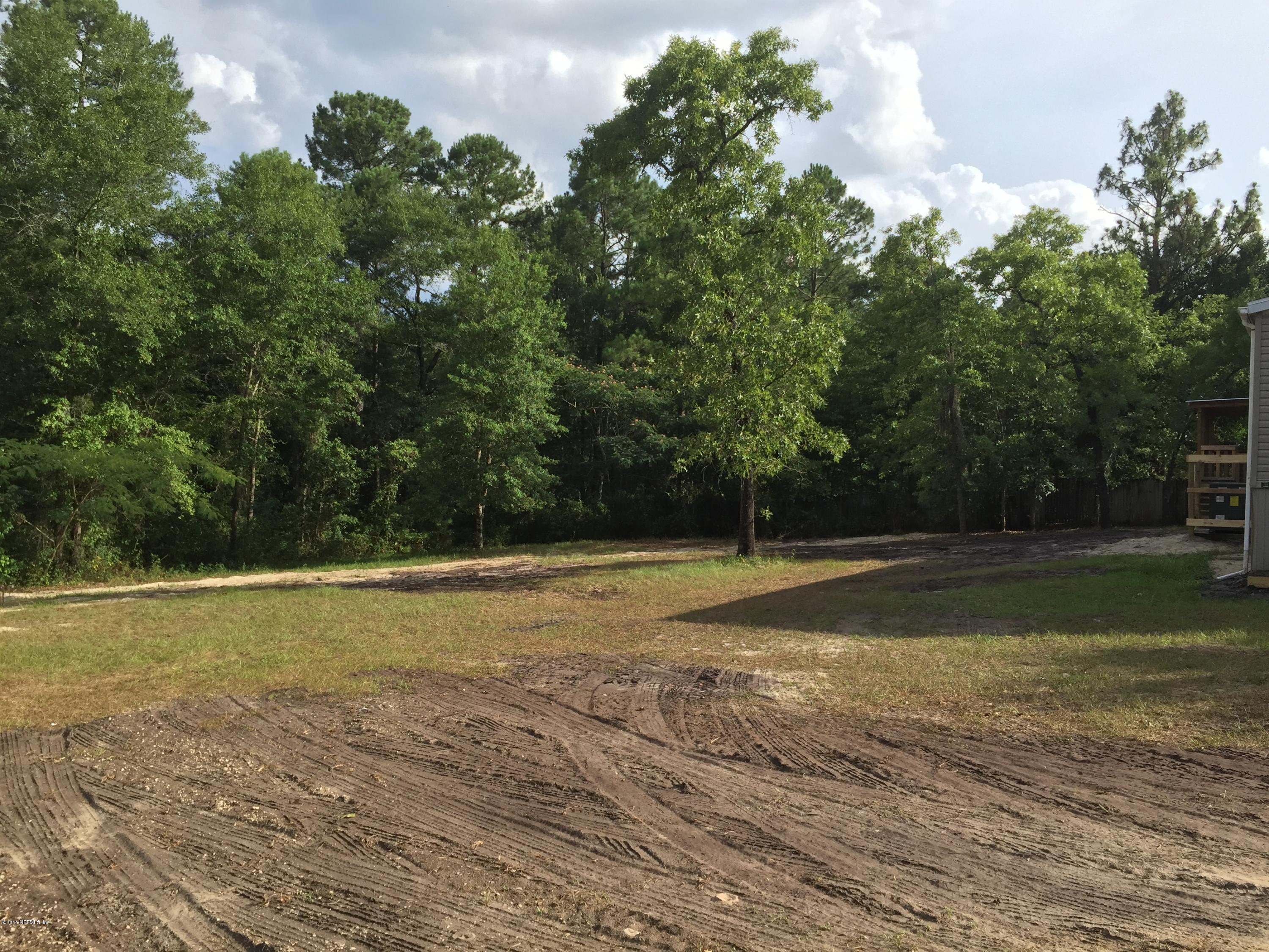 4653 Calendula Avenue Middleburg, FL 32068 - Photo 5 of 50 a view of a field with trees in front of it