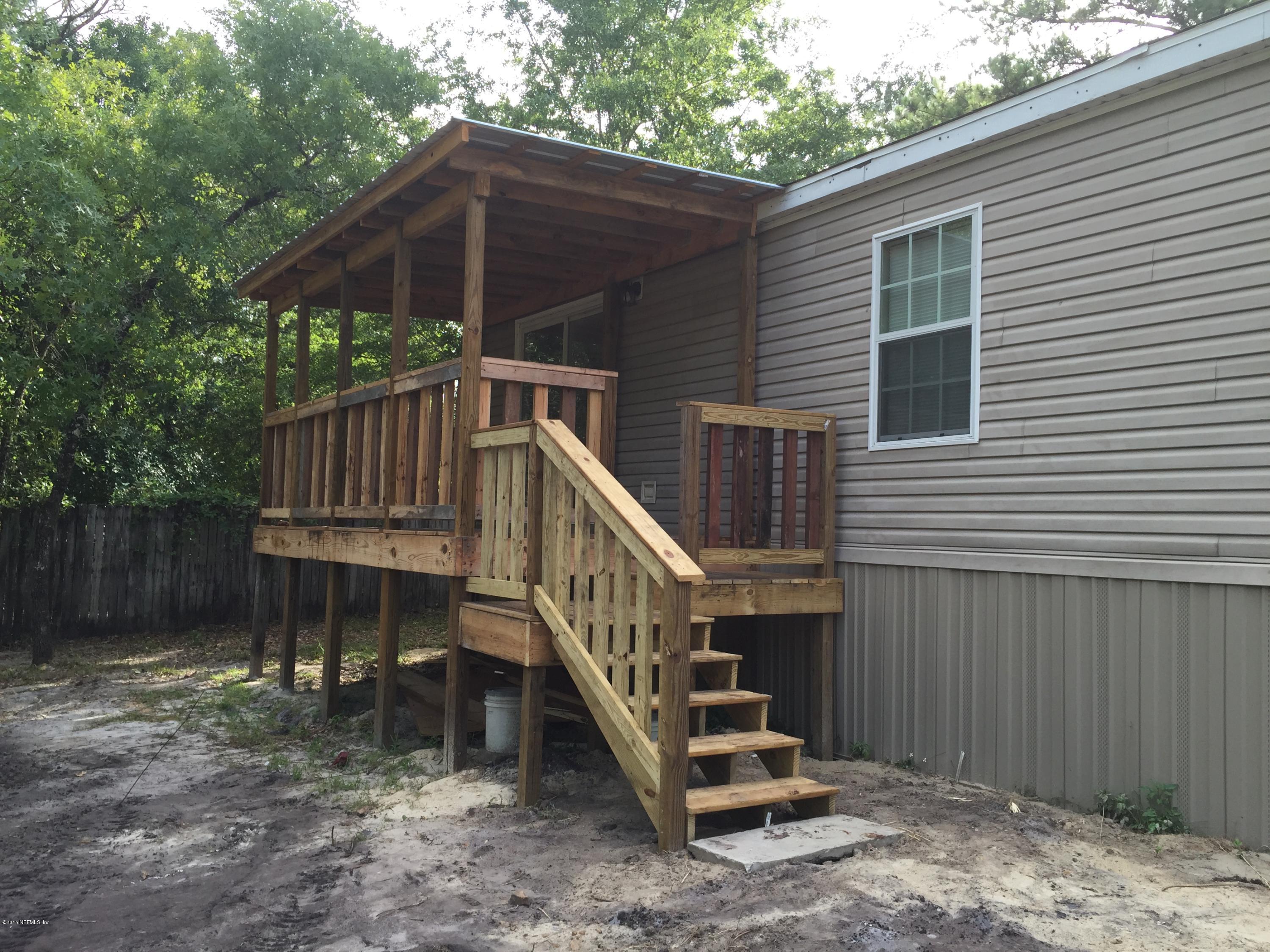 4653 Calendula Avenue Middleburg, FL 32068 - Photo 9 of 50 a view of a small house with wooden deck