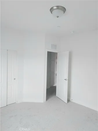 a view of a refrigerator in kitchen and entryway