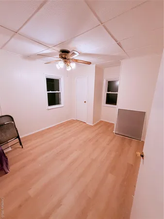 a view of a livingroom with a stove and a chandelier