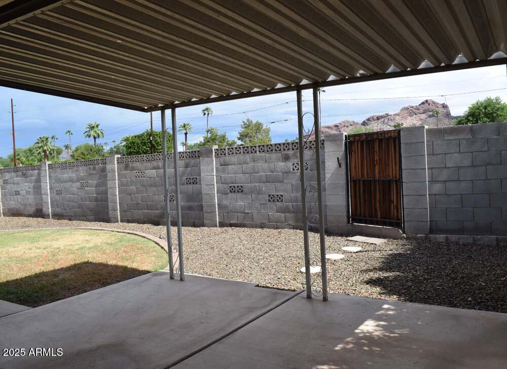 4456 East Campbell Avenue Phoenix, AZ 85018 - Photo 12 of 12 a view of a backyard with wooden fence