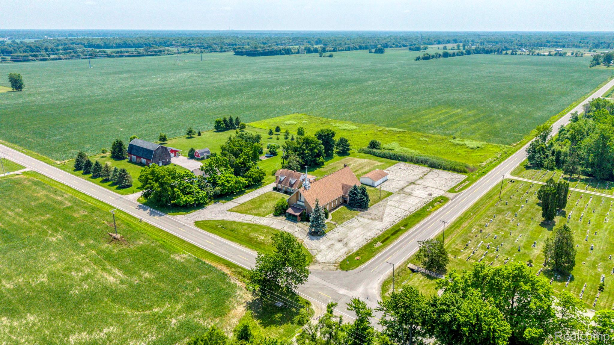 9735 Dolan Road Columbus, MI 48063 - Photo 10 of 63 Aerial perspective showcasing multiple structures surrounded by expansive green fields