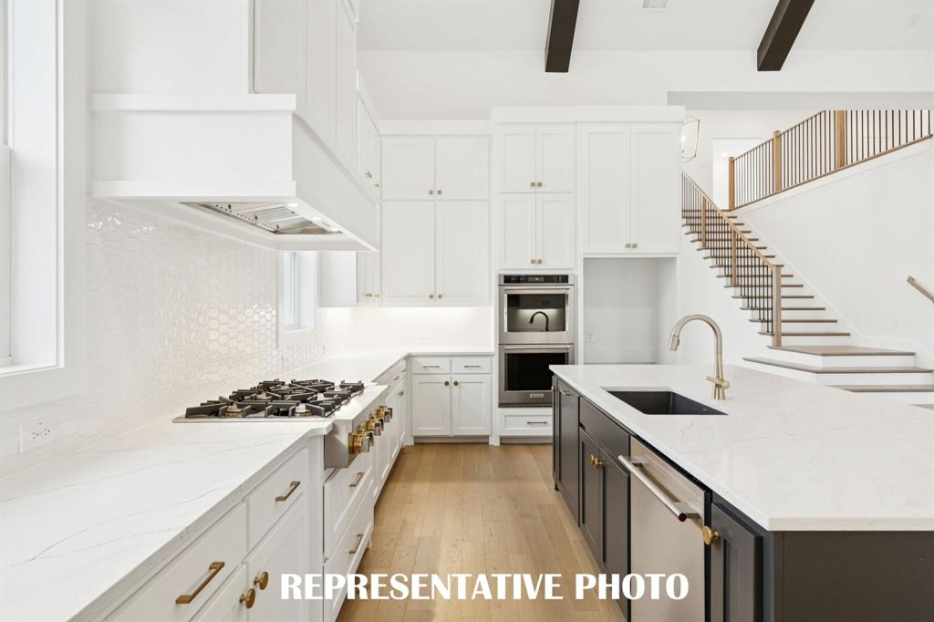 4051 Gambel Road Prosper, TX 75078 - Photo 6 of 20 Beautiful cabinetry, gorgeous countertops and elegant backsplash effortlessly pair with contemporary stainless steel to create a kitchen for the ages! REPRESENTATIVE PHOTO