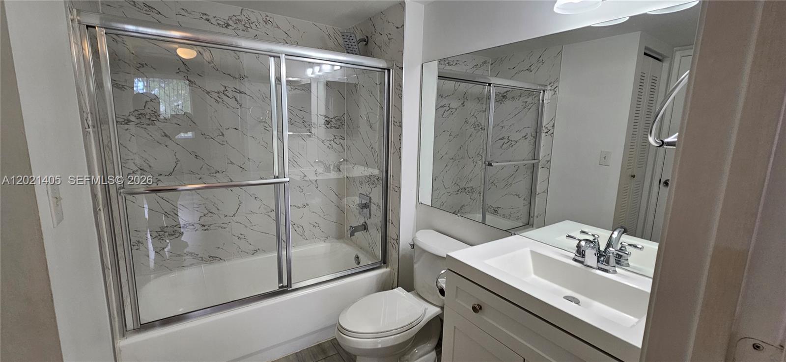 3870 Lyons Road, Unit 2098 Pompano Beach, FL 33073 - Photo 21 of 31 a bathroom with a granite countertop sink toilet and shower