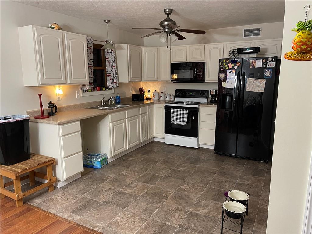 210 Marble Terrace Grindstone, PA 15442 - Photo 2 of 7 a kitchen with stainless steel appliances a stove a sink and a refrigerator