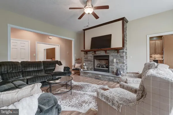 a kitchen with kitchen island granite countertop a sink cabinets and stainless steel appliances