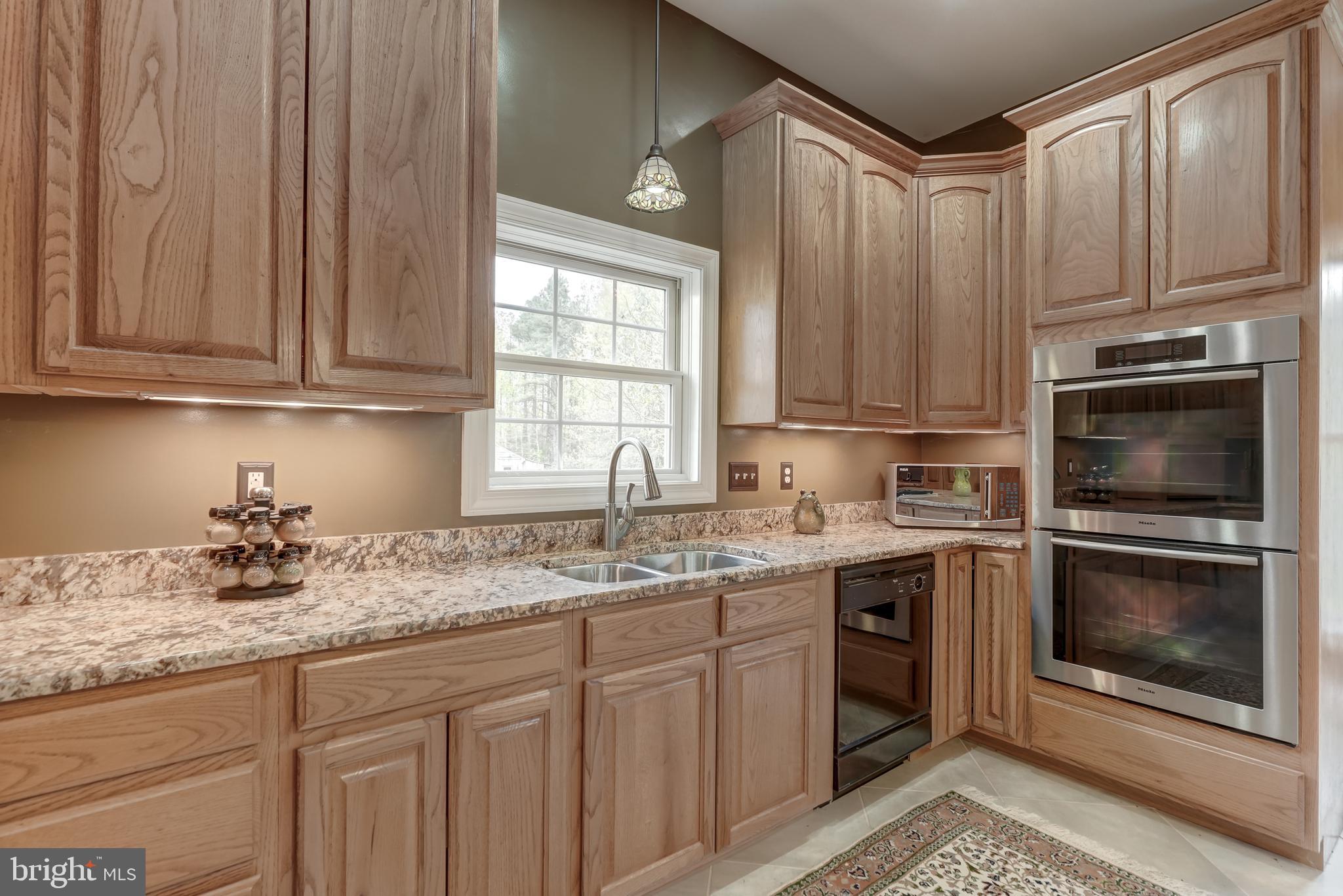 2066 Byrd's Mill Road Newtown, VA 23126 - Photo 15 of 61 a kitchen with stainless steel appliances granite countertop a sink a stove a microwave and cabinets