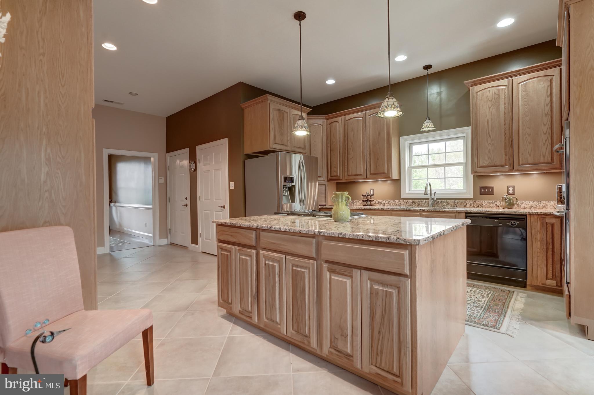 2066 Byrd's Mill Road Newtown, VA 23126 - Photo 18 of 61 a kitchen with kitchen island granite countertop a sink cabinets and stainless steel appliances