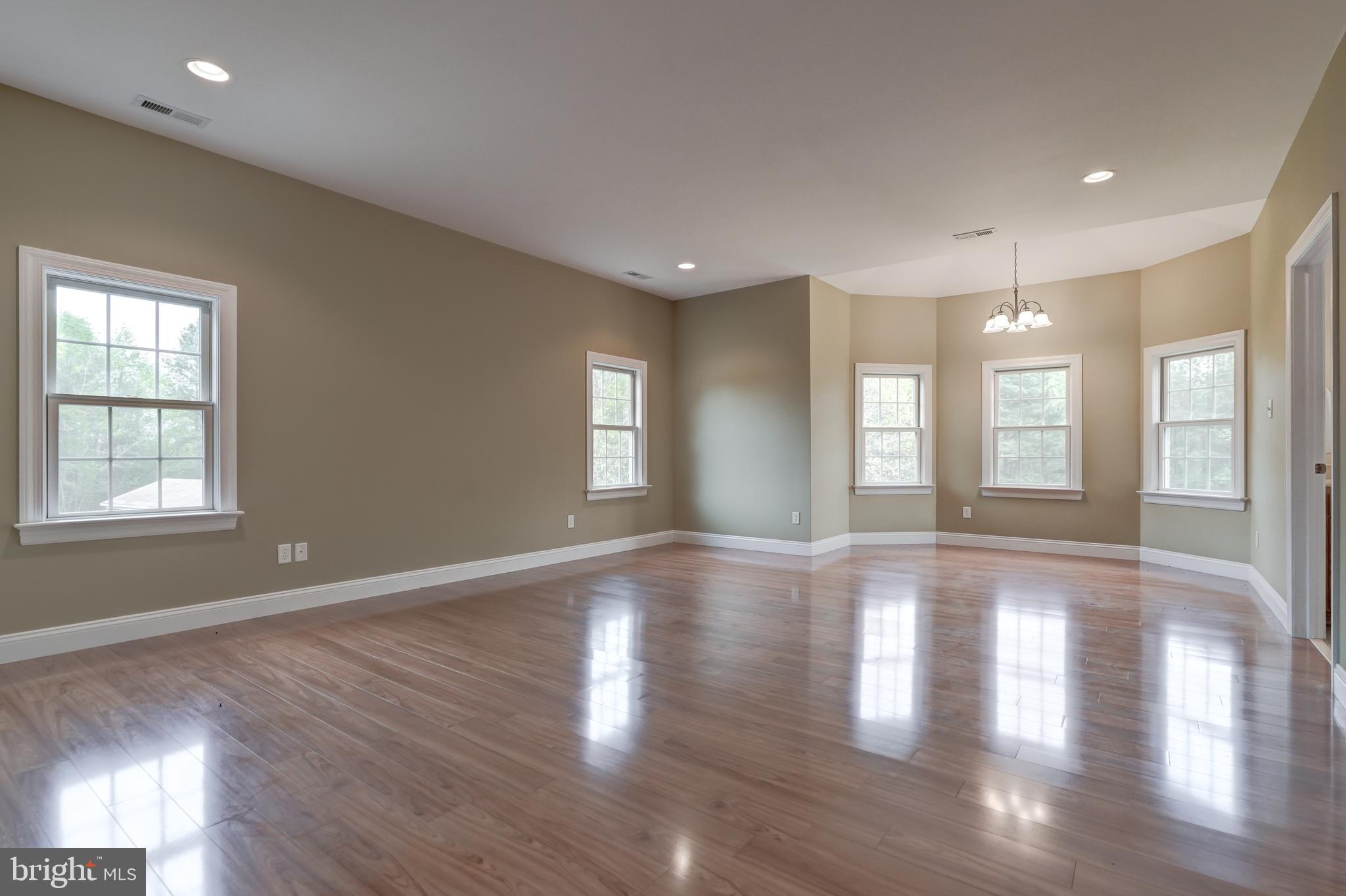 2066 Byrd's Mill Road Newtown, VA 23126 - Photo 23 of 61 a view of an empty room with wooden floor and a window