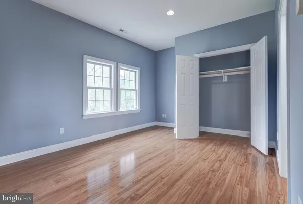 an empty room with wooden floor and fireplace